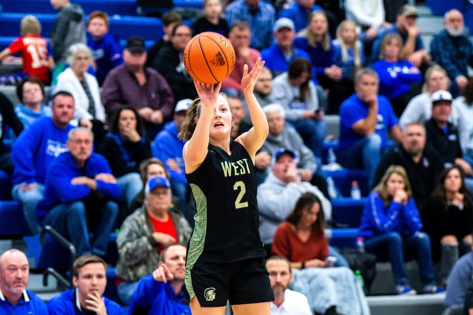 Iowa City West's Lucy Wolf makes a 3-point basket during a high school girls basketball game against Clear Creek Amana