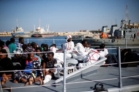 FILE PHOTO: Migrants arrive at a naval base after they were rescued by Libyan coastal guards in Tripoli, Libya November 6, 2017. REUTERS/Ahmed Jadallah/File Photo
