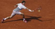 Stan Wawrinka of Switzerland returns the ball to his compatriot Roger Federer during their men's quarter-final match during the French Open tennis tournament at the Roland Garros stadium in Paris, France, June 2, 2015. REUTERS/Gonzalo Fuentes