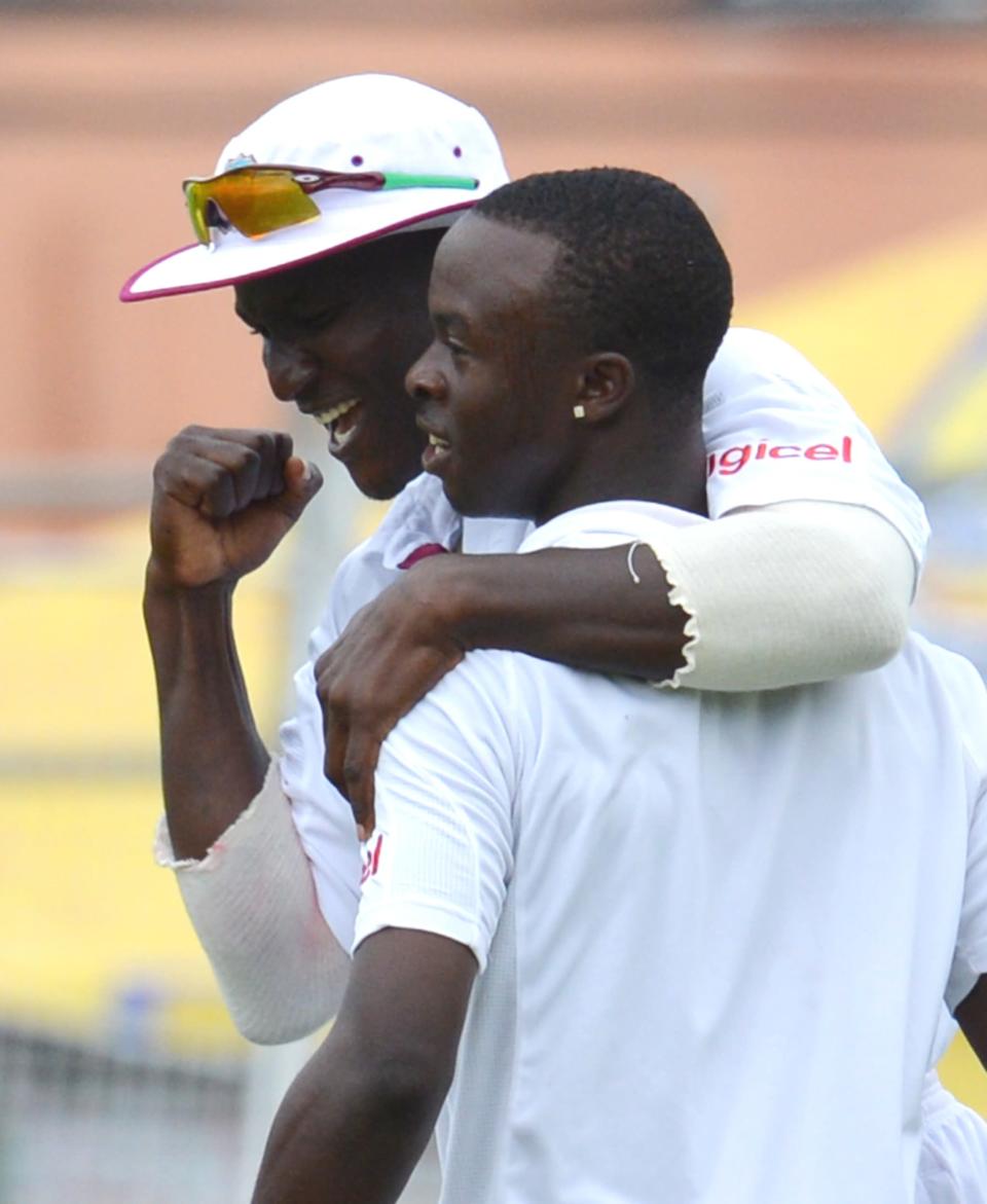 West Indies Kemar Roach (R) celebrates bowling out Australian batsman Ben Hilfenhaus with teammate Darren Sammy (L) during the final day of the second-of-three Test matches between Australia and West Indies April19, 2012 at Queen's Park Oval in Port of Spain, Trinidad.