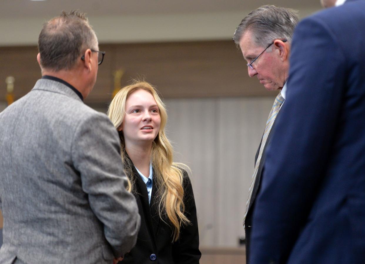 Maya Kowalski, center, with her father, Jack Kowalsi, left, talks to her attorney Greg Anderson during a break in proceedings Thursday, Oct. 19, 2023 at the South County Courthouse in Venice, Florida. The Kowalski family is suing Johns Hopkins All Children's Hospital for false imprisonment, negligent infliction of emotional distress, medical negligence, battery, and other claims more than a year after the family matriarch, Beata Kowalski, took her life following allegations she was abusing her daughter, Maya Kowalski. Pool photo/Mike Lang/Sarasota Herald-Tribune