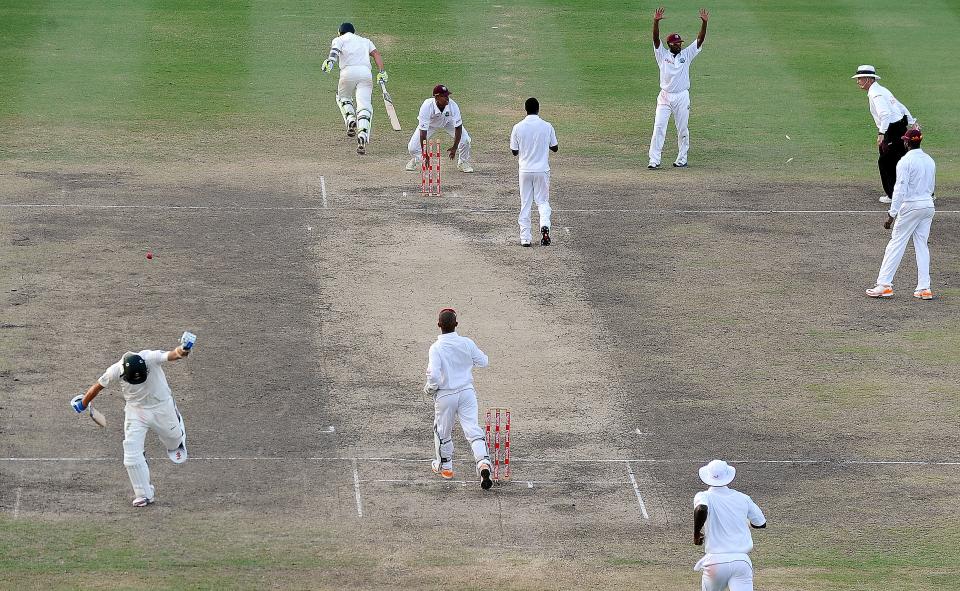 Australian cricketers Ryan Harris (L-bottom) and Ben Hilfenhaus (top-L) take a run to win during the final day of the first-of-three Test matches between Australia and West Indies at the Kensington Oval stadium in Bridgetown on April 11, 2012. Australia defeated West Indies by 3 wickets. AFP PHOTO/Jewel Samad (Photo credit should read JEWEL SAMAD/AFP/Getty Images)