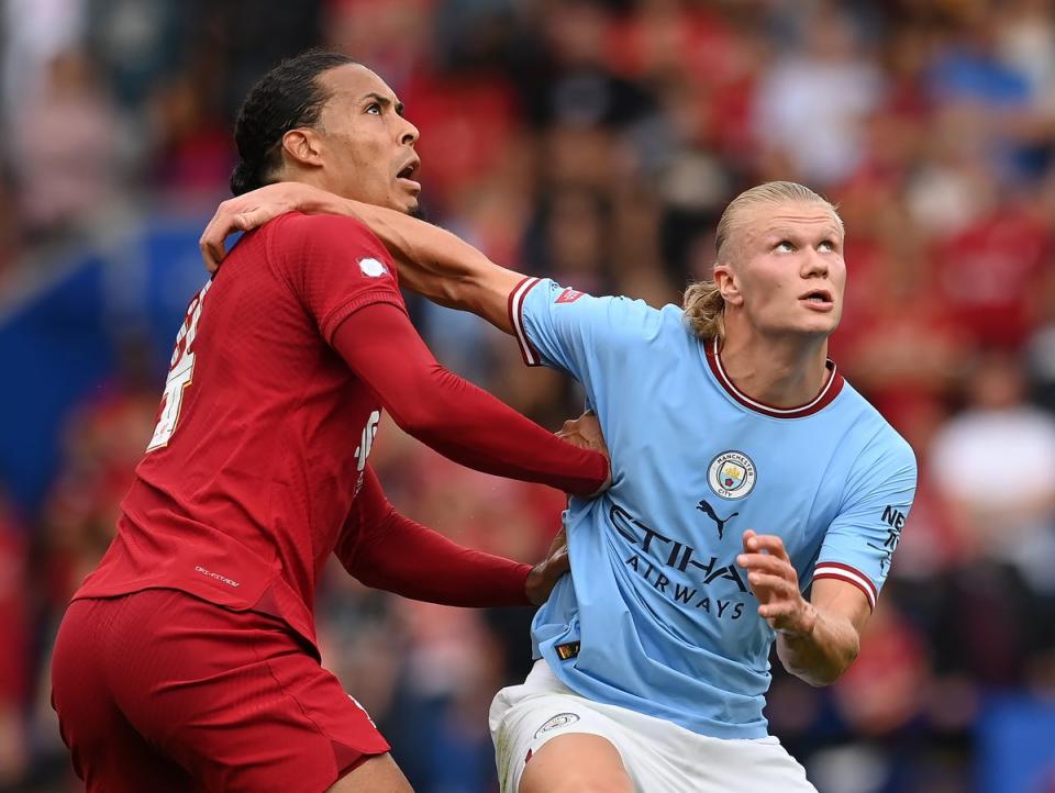 Liverpool defender Virgil van Dijk challenges for the ball with Manchester City striker Erling Haaland (The FA via Getty Images)