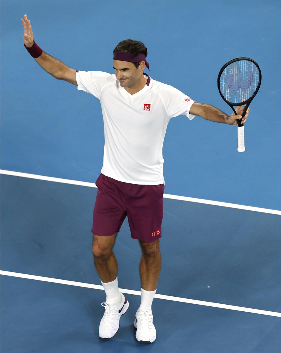 Switzerland's Roger Federer celebrates after defeating Hungary's Marton Fucsovics in their fourth round singles match at the Australian Open tennis championship in Melbourne, Australia, Sunday, Jan. 26, 2020. (AP Photo/Andy Wong)