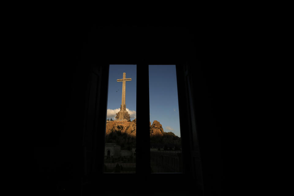 The Valley of the Fallen mausoleum is framed by a window near El Escorial, outskirts of Madrid, Spain, Sunday, Oct. 13, 2019. After a tortuous judicial and public relations battle, Spain's Socialist government has announced that Gen. Francisco Franco's embalmed body will be relocated from a controversial shrine to a small public cemetery where the former dictator's remains will lie along his deceased wife. (AP Photo/Manu Fernandez)