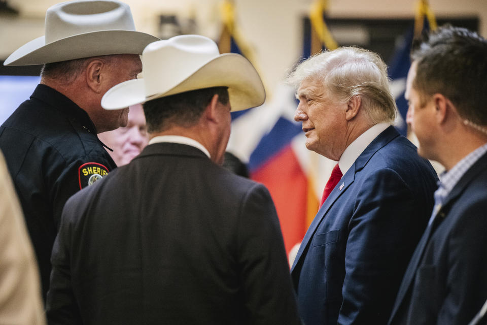 Former President Donald Trump greets law enforcement while arriving at a border security briefing to discuss further plans in securing the southern border wall on Wednesday, June 30, 2021, in Weslaco, Texas. (Brandon Bell/Pool via AP)