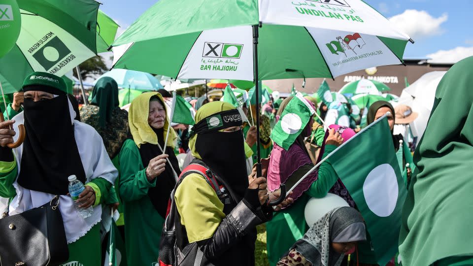 Supporters of the Malaysia Islamic Party (PAS) gather for a rally, dressed in the party's signature green colors. - MOHD RASFAN/AFP/AFP/Getty Images