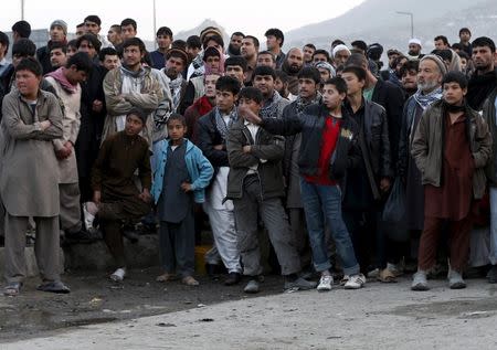 People gather at the site of a suicide attack in Kabul March 25, 2015. REUTERS/Mohammad Ismail