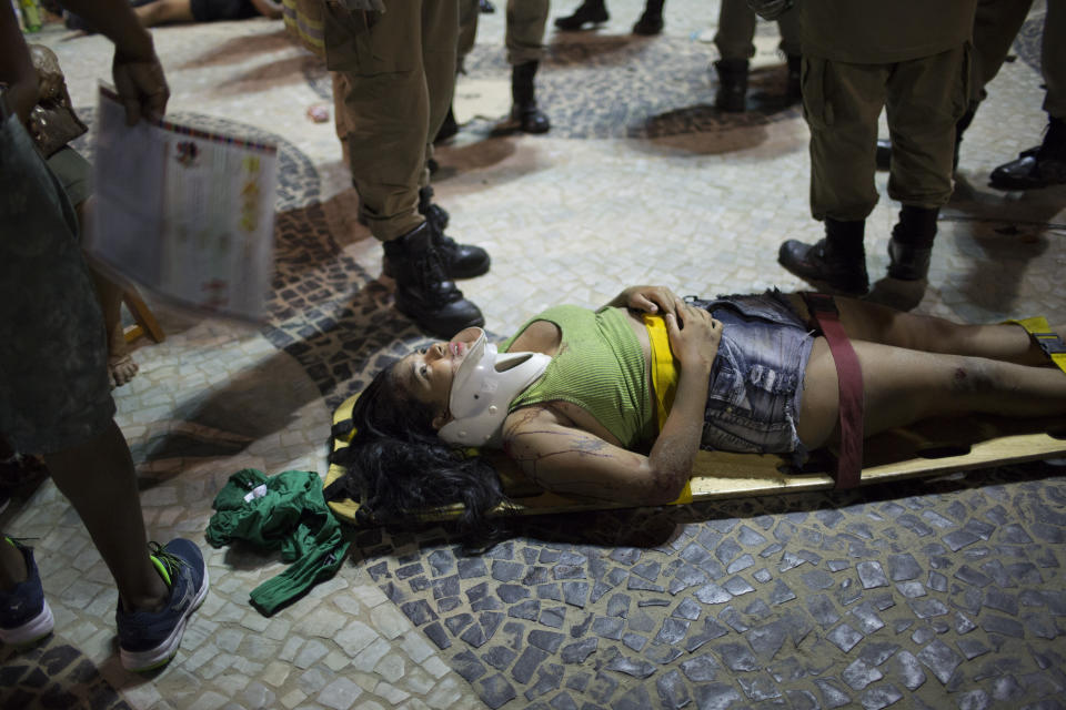 <p>A woman lies on a stretcher waiting for an ambulance after a car drove into the crowded seaside boardwalk along Copacabana beach in Rio de Janeiro, Brazil, Thursday, Jan. 18, 2018. (Photo: Silvia Izquierdo/AP) </p>