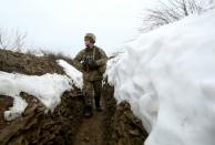 An Ukrainian soldier walks in a trench on the frontline with Russia-backed separatists near Luganske village in the Donetsk region on January 11, 2022 (AFP/Anatolii STEPANOV)