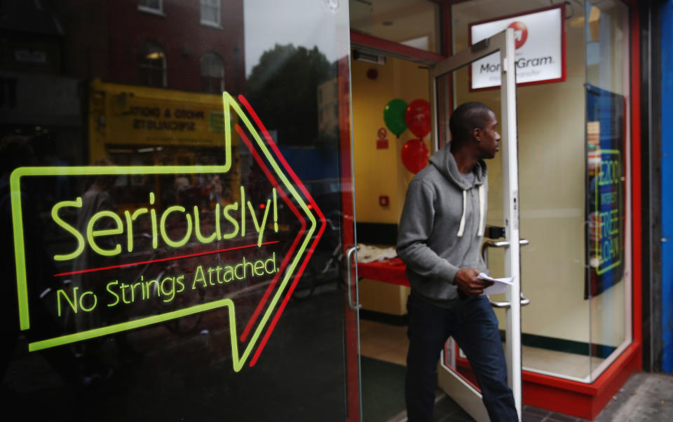 LONDON, ENGLAND - OCTOBER 03:  A man walks out of a payday loan store in Dalston on October 3, 2013 in London, England. Payday loan stores are to face tougher regulations after moves proposed by the Financial Conduct Authority (FCA) call on more responsible lending.  (Photo by Dan Kitwood/Getty Images)