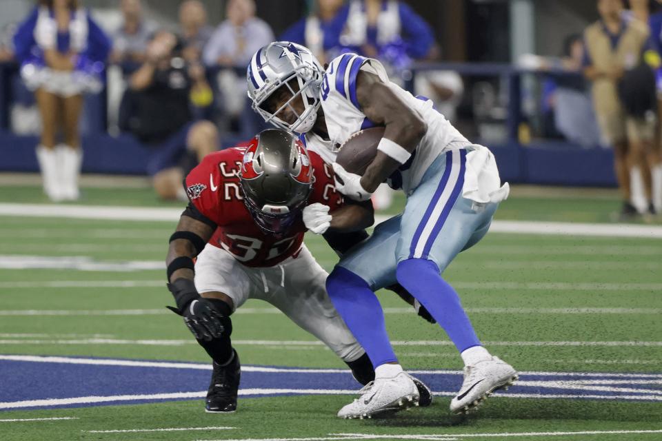 Dallas Cowboys wide receiver Noah Brown (85) is stopped by Tampa Bay Buccaneers safety Mike Edwards (32) after catching a pass in the second half of a NFL football game in Arlington, Texas, Sunday, Sept. 11, 2022. (AP Photo/Michael Ainsworth)