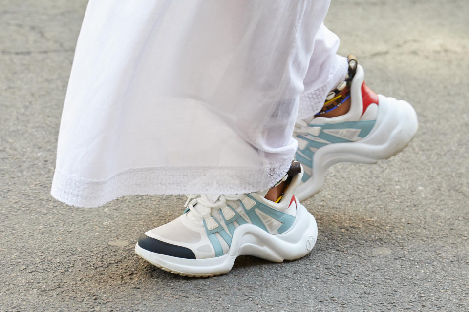 White and blue Louis Vuitton sneakers. - Credit: Shutterstock / andersphoto