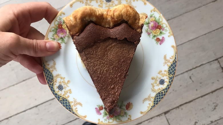 hand holding plated pie slice