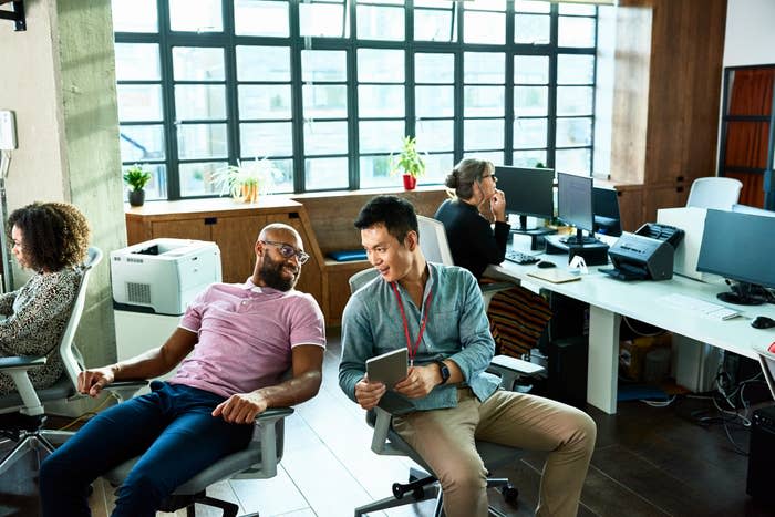 people working in an open floor office