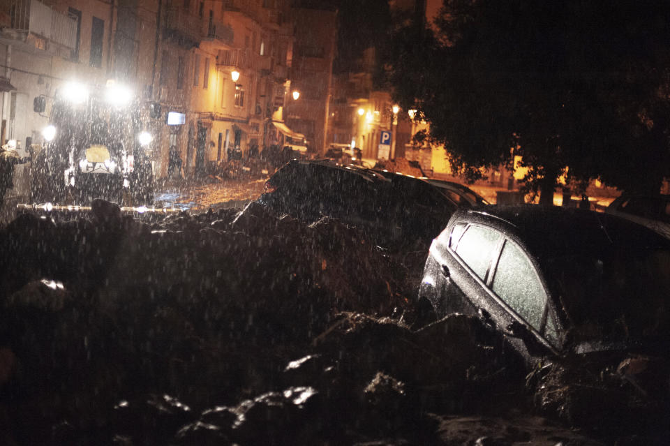 Cars among other debris litter the street in Bitti, Sardinia, Italy, Saturday, Nov. 28, 2020. The town of Bitti in Sardinia was hit by a storm and flooded by a massive mudslide that killed at least 2 people on Saturday. (Alessandro Tocco/LaPresse via AP)