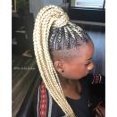 This blonde style, anchored by a set of cornrows done at <a href="https://thebraidlounge.com/" rel="nofollow noopener" target="_blank" data-ylk="slk:The Braid Lounge;elm:context_link;itc:0;sec:content-canvas" class="link ">The Braid Lounge</a> in Virginia Beach, is the stuff dreams are made of. The client's shaved sides give this style an edgy feel.