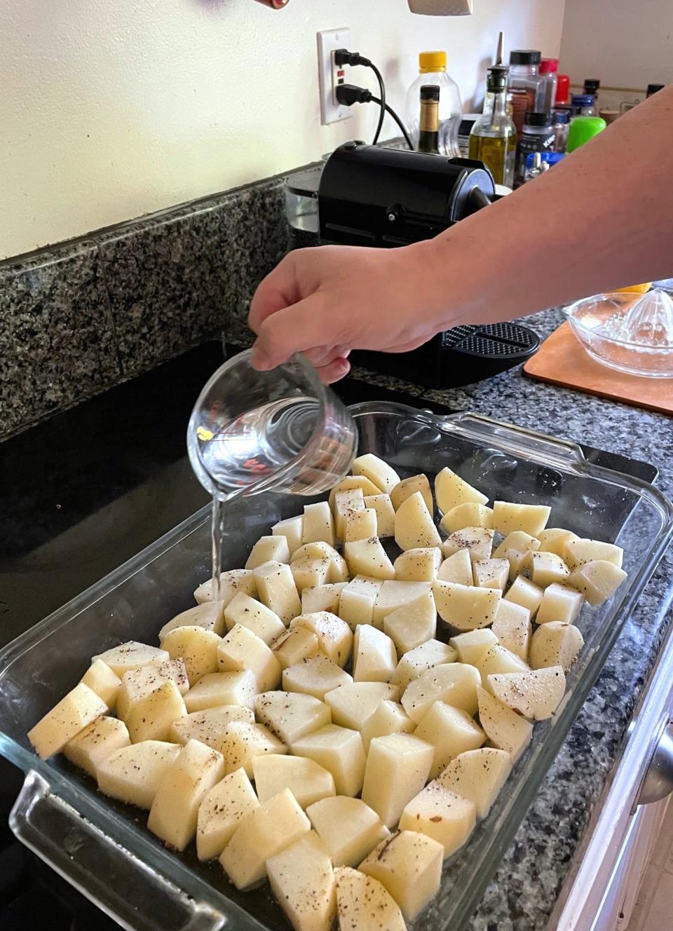 Adding water to Dad's Greek Lemon Potatoes