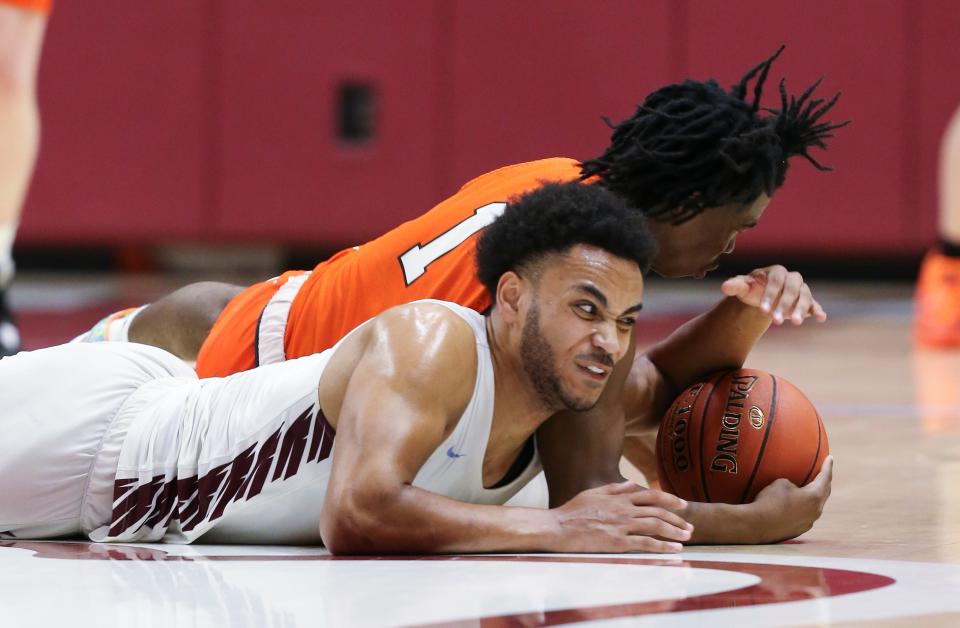 J-Town’s Lukus McDaniels (3) battled Desales’s DaVon Martin (1) for a loose ball during the championship of the 6th Region tournament at Bellarmine Knights Hall in Louisville, Ky. on Mar. 6, 2023.   