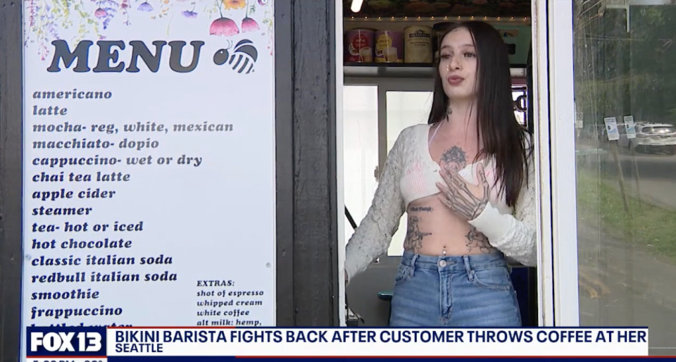 A barista in crop top and jeans stands next to a coffee shop menu. Headline reads, "Bikini barista fights back after customer throws coffee at her - Seattle."