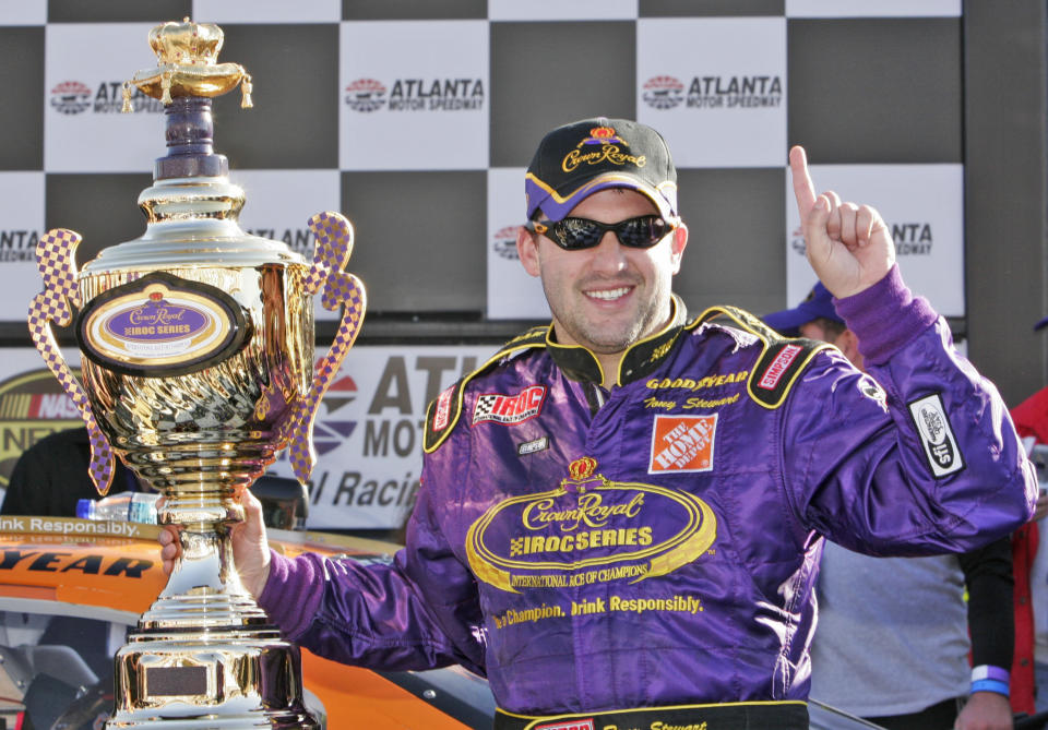 FILE - Tony Stewart celebrates his International Race of Champions (IROC) championship in victory lane at Atlanta Motor Speedway in Hampton, Ga., in this Saturday, Oct. 28, 2006, file photo. Superstar Racing Experience (SRX), disclosed the format it will use Thursday, May 6, 2021, to The Associated Press when the all-star series launches this summer at Stafford Motor Speedway in Connecticut on June 12 for the first of six Saturday night short-track races across the country. Stewart and co-founder Ray Evernham modeled the series after the popular but defunct International Race of Champions that pitted drivers from multiple formulas in identically prepared cars at various tracks for 30 years. (AP Photo/Gene Blythe, File)