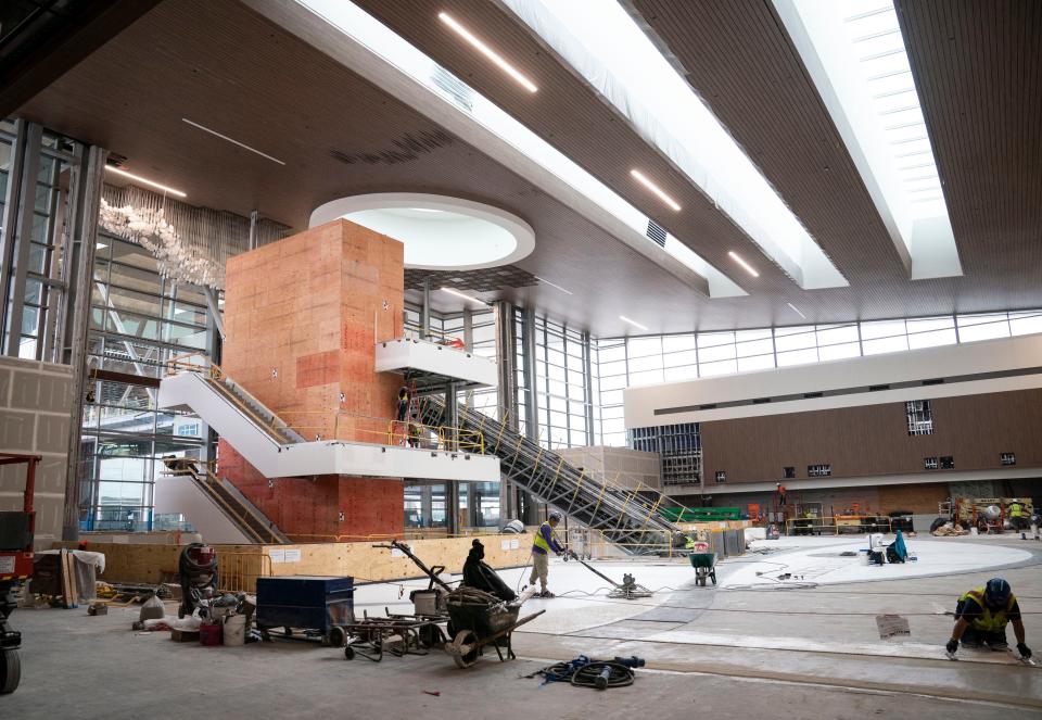 Construction workers build the new main terminal at the Nashville International Airport Friday, Dec. 9, 2022 in Nashville, Tenn. 