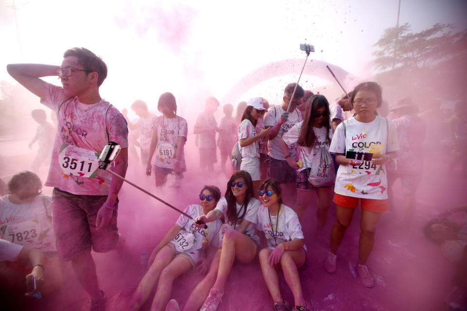 <p>Participants enjoy the ‘Color Me Run’ festival in Hanoi, Vietnam, May 28, 2016. The festival which was inspired by the Holi Festival from India, attracted thousands of teenagers this year. (EPA/LUONG THAI LINH) </p>