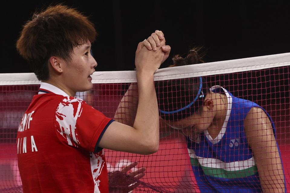 Tokyo 2020 Olympics - Badminton - Women's Singles - Gold medal match - MFS - Musashino Forest Sport Plaza, Tokyo, Japan – August 1, 2021.  Chen Yufei of China and Tai Tzu-Ying of Taiwan interact at the net after Chen won the match. REUTERS/Leonhard Foeger