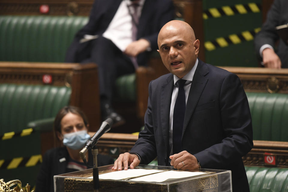 In this handout photo provided by UK Parliament, Britain's Health Secretary Sajid Javid updates MPs on the governments coronavirus plans, in the House of Commons, London, Monday, July 5, 2021. British Prime Minister Boris Johnson says people in England will no longer be required by law to wear face masks in indoor public spaces and to keep at least 1 meter (3 feet) apart as soon as later this month. Johnson on Monday confirmed plans to reopen society despite rising coronavirus cases. (Jessica Taylor/UK Parliament via AP)