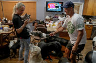 <p>Gretchen and Ron Levine of A Paw Above in Hollywood, Fla., are taking care of 20 dogs and 21 cats as they’ve been inundated with pet care requests by people fleeing Hurricane Irma. (Photo: Susan Stocker/Sun Sentinel/TNS via Getty Images) </p>