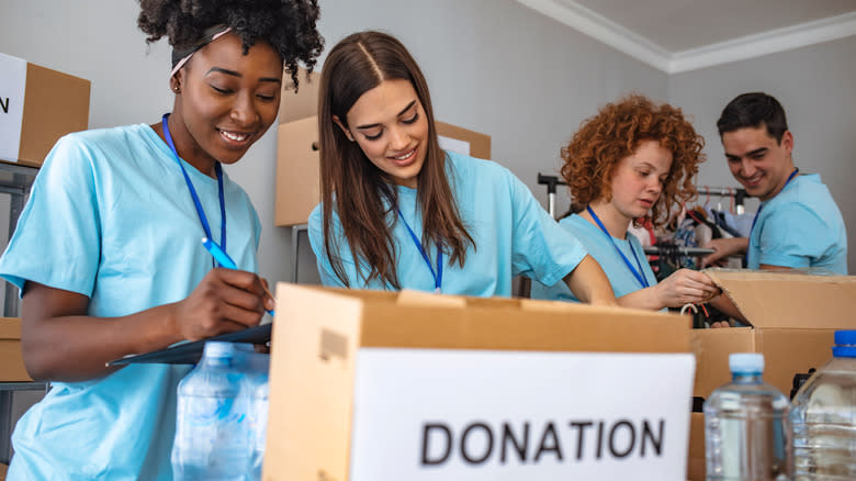 Charity volunteers accepting food donations