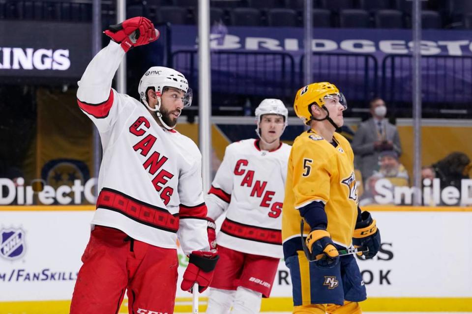 Carolina Hurricanes center Vincent Trocheck, left, celebrates after scoring a goal against the Nashville Predators in the first period of an NHL hockey game Tuesday, March 2, 2021, in Nashville, Tenn. (AP Photo/Mark Humphrey)