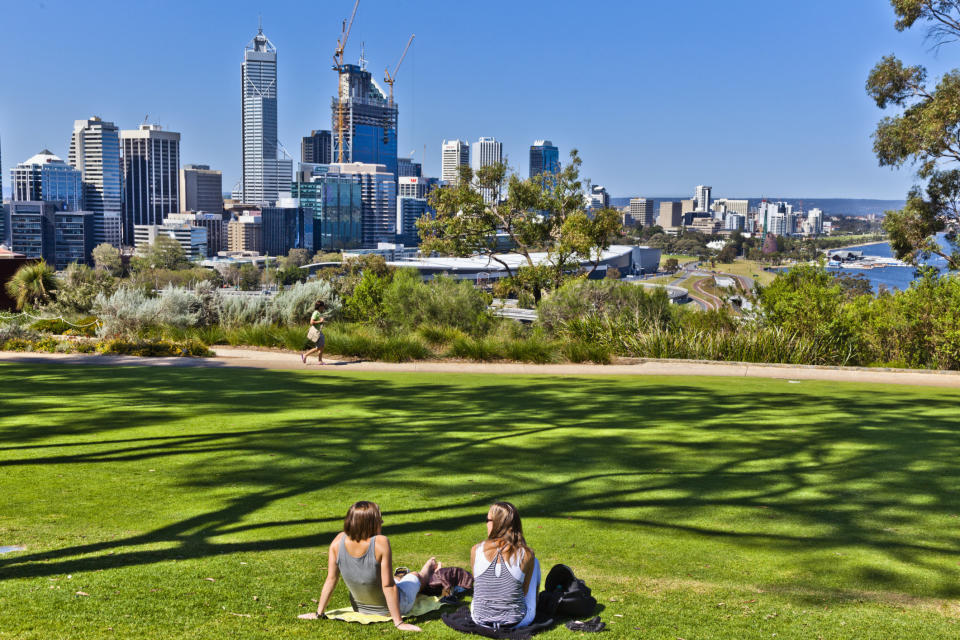 Two people relax&nbsp;at Kings Park in view of&nbsp;the Perth skyline. The Australian city scored a 95.9 on the livability scale.