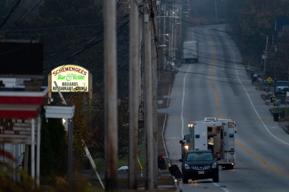 Investigators are outside a bar in the aftermath of a mass shooting in Lewiston, Maine, Friday, Oct. 27, 2023. Shocked and fearful Maine residents were keeping to their homes for a second night as hundreds of police and FBI agents search intently for Robert Card, the suspect.