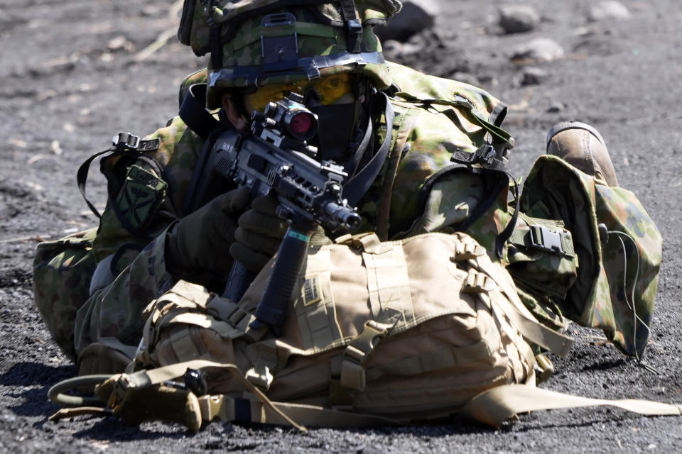 One of members of Japan Ground Self-Defense Force (JGSDF) takes position during a joint military helicopter borne operation drill between JGSDF and U.S. Marines at Higashi Fuji range in Gotemba, southwest of Tokyo, Tuesday, March 15, 2022. (AP Photo/Eugene Hoshiko)