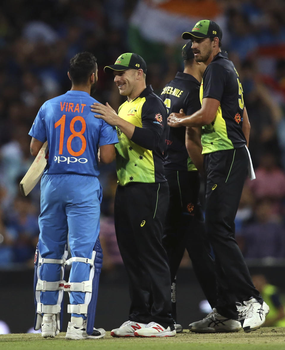 India's Virhat Kohli, left, is congratulated by Australia's captain Aaron Finch after winning their Twenty20 cricket match in Sydney, Sunday, Nov. 25, 2018. (AP Photo/Rick Rycroft)