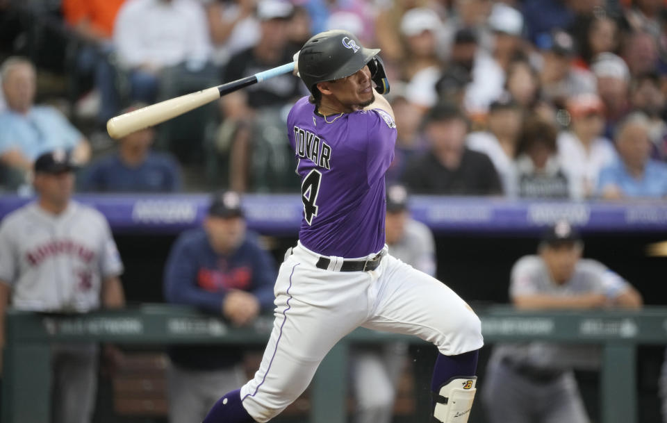 Colorado Rockies' Ezequiel Tovar watches his RBI triple against the Houston Astros during the fourth inning of a baseball game Tuesday, July 18, 2023, in Denver. (AP Photo/David Zalubowski)