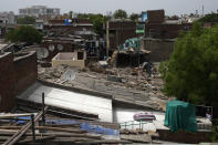 A white reflective painted rooftop which brings down indoor temperature in summer is seen in a shanty town, in Ahmedabad, India, Monday, May 23, 2022. The intense heat wave sweeping through South Asia was made more likely due to climate change and it is a sign of things to come. An analysis by international scientists said that this heat wave was made 30-times more likely because of climate change, and future warming would make heat waves more common and hotter in the future. (AP Photo/Ajit Solanki)