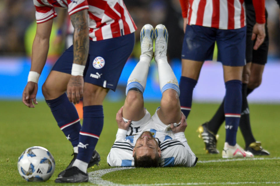 Argentina's Lionel Messi lies on his back after being fouled during a qualifying soccer match for the FIFA World Cup 2026 against Paraguay at the Monumental stadium in Buenos Aires, Argentina, Thursday, Oct. 12, 2023. (AP Photo/Gustavo Garello)