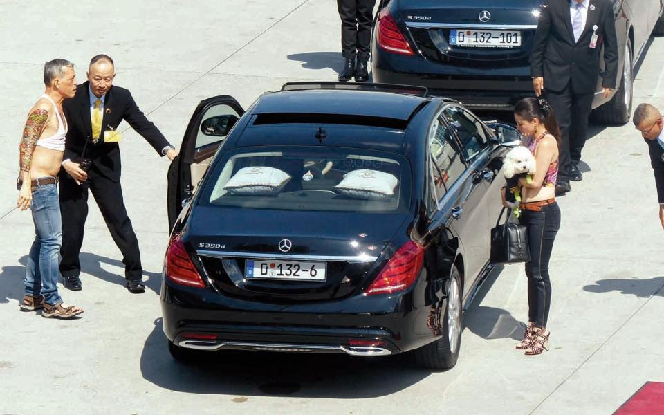 K.M.V arriving at Munich’s airport with his Boeing 737 wearing a cropped top, associate carrying his dog Foo Foo - Splash News