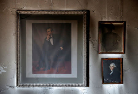 Paintings are seen in the damage caused in a firebomb attack on local offices of the North Carolina Republican Party in Hillsborough, North Carolina, U.S. October 17, 2016. REUTERS/Chris Keane