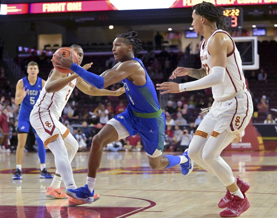 USC Trojans guard Reese Dixon-Waters (2) and USC Trojans guard Tre White (22) defend Florida Gulf Coast Eagles guard Dahmir Bishop (1) as he drives to the basket in the second half at Galen Center.