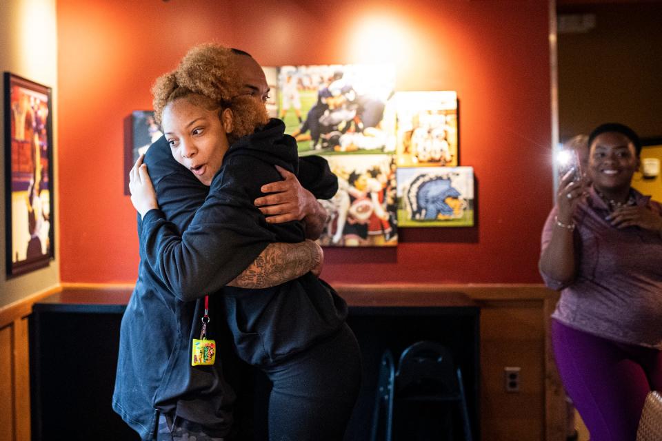 Amiyah Johnson, 16, embraces her father Ronnell Johnson at the Applebee's in Livonia on Wednesday, June 1, 2022.