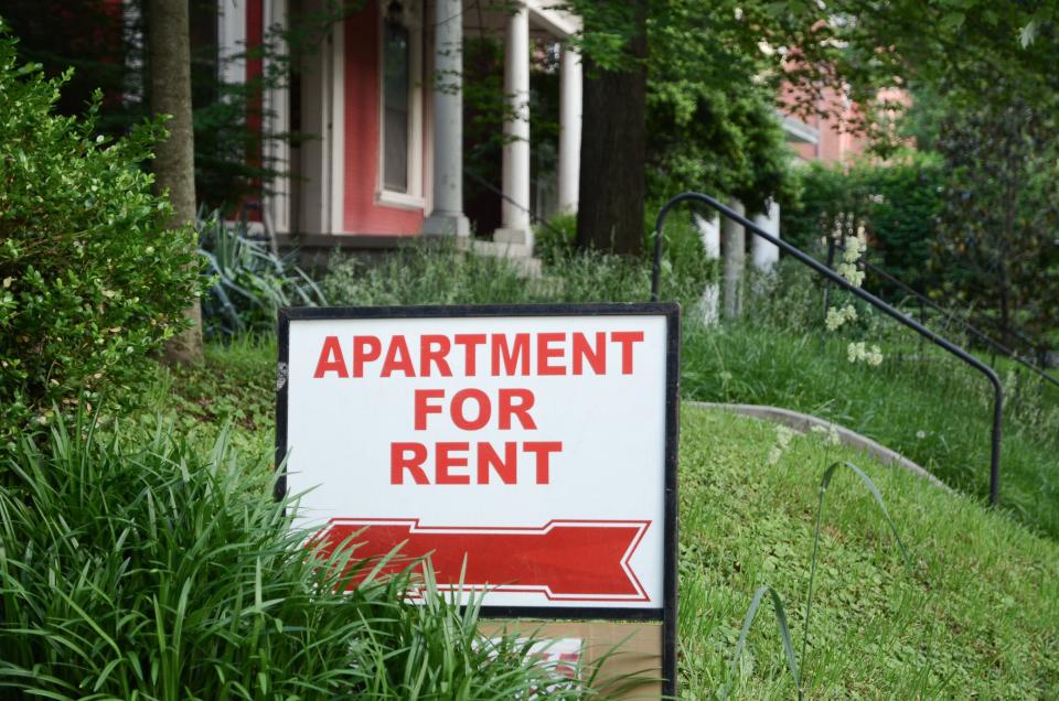 Apartment for rent sign displayed on residential street. Shows demand for housing, rental market, landlord-tenant relations.