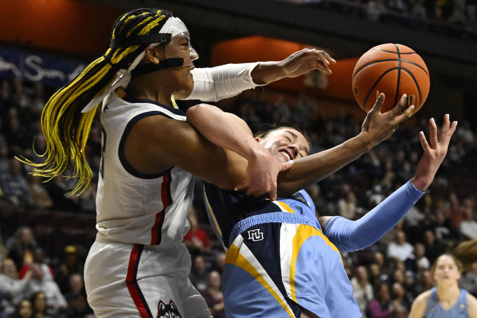 Connecticut's Aaliyah Edwards (3) and Marquette's Chloe Marotta (52) fight for a rebound during the first half of an NCAA college basketball game in the semifinals of the Big East Conference tournament at Mohegan Sun Arena, Sunday, March 5, 2023, in Uncasville, Conn. (AP Photo/Jessica Hill)