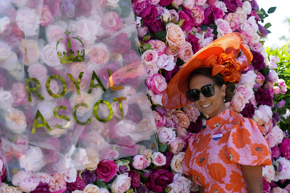 A racegoer poses for a photo, on the second day of of the Royal Ascot horserace meeting, at Ascot Racecourse, in Ascot, England, Wednesday, June 15, 2022. (AP Photo/Alastair Grant)