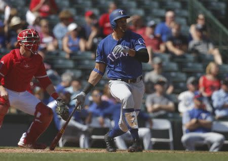 Feb 28, 2019; Tempe, AZ, USA; Texas Rangers first baseman Ronald Guzman (11) hits a home run in the first inning during a spring training game against the Los Angeles Angels at Tempe Diablo Stadium. Mandatory Credit: Rick Scuteri-USA TODAY Sports