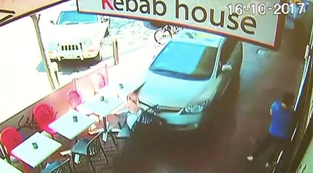 CCTV vision captures the moment the car smashes into cafe tables and chairs. Source: 7 News