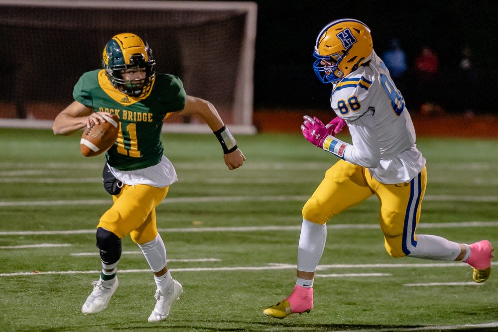 Francis Howell's Brett Norfleet (88) chases down Rock Bridge's Nate Dent (11) during a game on Oct. 22, 2021, at Rock Bridge High School.