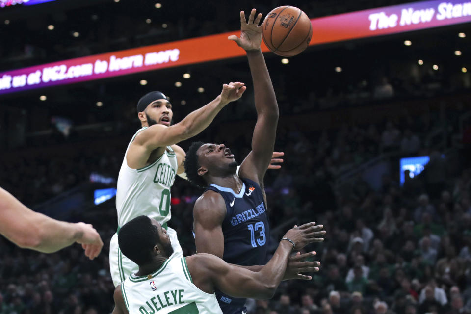 Memphis Grizzlies forward Jaren Jackson Jr. (13) drives past Boston Celtics forwards Jayson Tatum (0) and Semi Ojeleye (37) during the first half of an NBA basketball game in Boston, Wednesday, Jan. 22, 2020. (AP Photo/Charles Krupa)